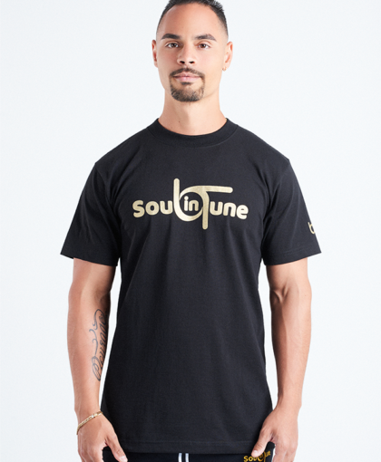 A man wearing a black t-shirt with the words soul to tune on it.