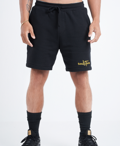 A man wearing black shorts and socks