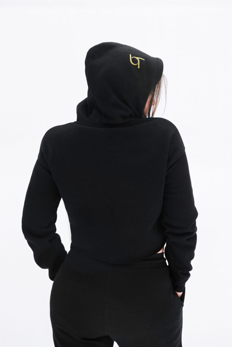 A woman wearing black and yellow hoodie